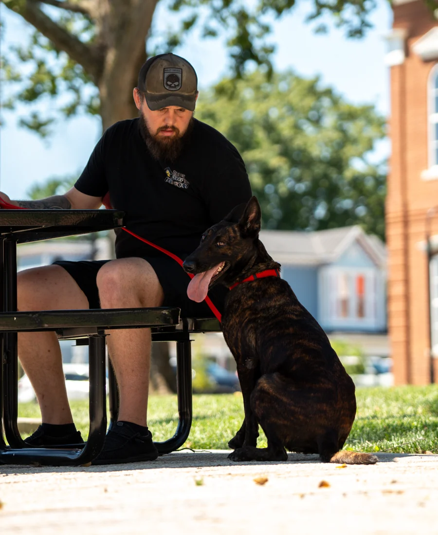 Black Woof Inn trainer with a trained dog in downtown La Grange, KY